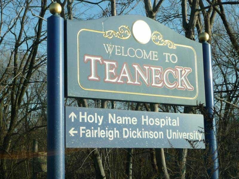 Quickbooks Cleanup teaneck - Image shows welcome to Teaneck sigh with arrow direction to Holy Name Hospital and Fairleigh Dickenson University